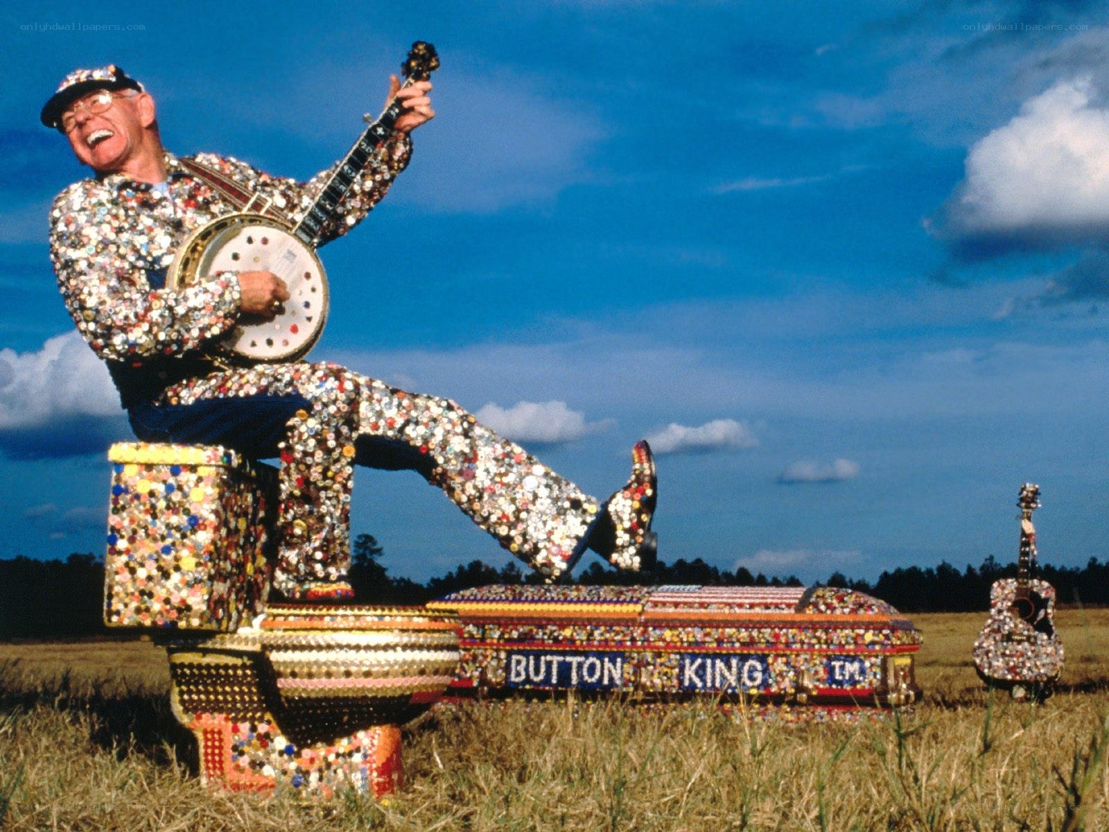Man in button-covered outfit playing banjo