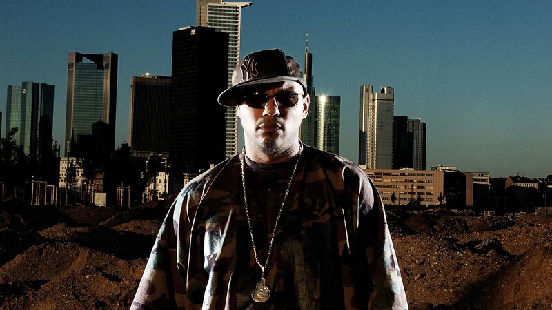 man in camouflage with city skyline