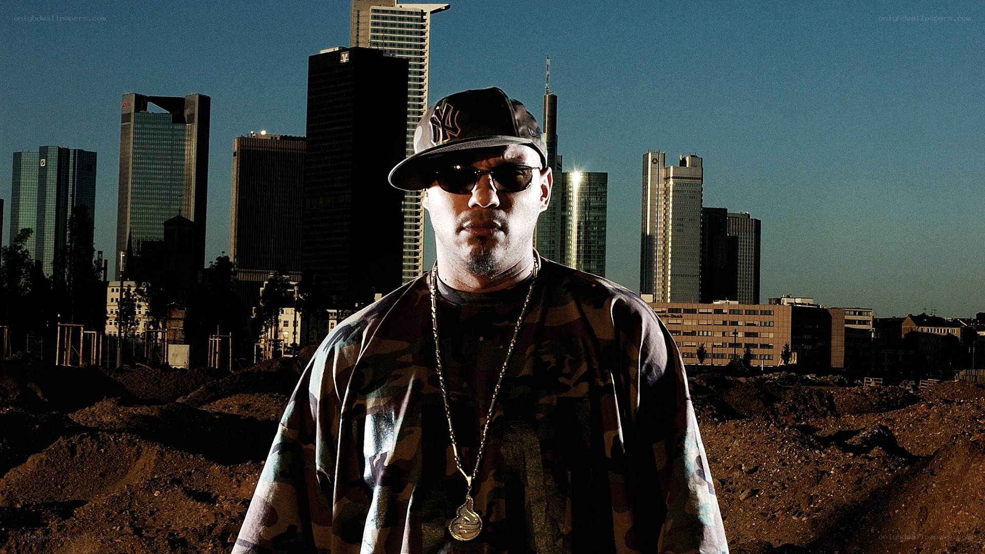 man in camouflage with city skyline
