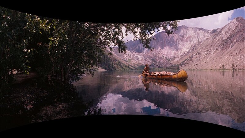 Man in canoe on mountain lake
