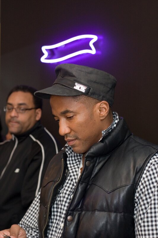 man in cap and leather vest