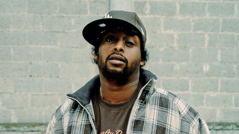 man in cap and plaid jacket