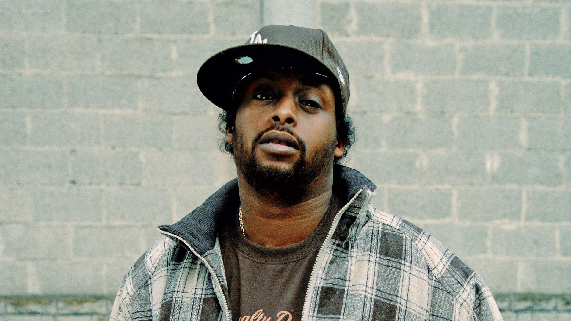 man in cap and plaid jacket