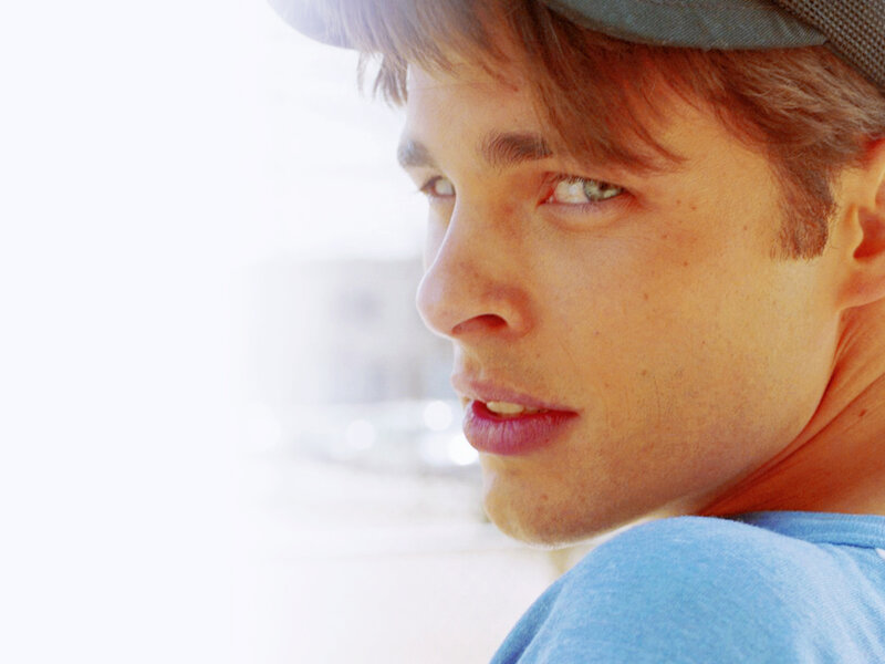man in cap looking over shoulder