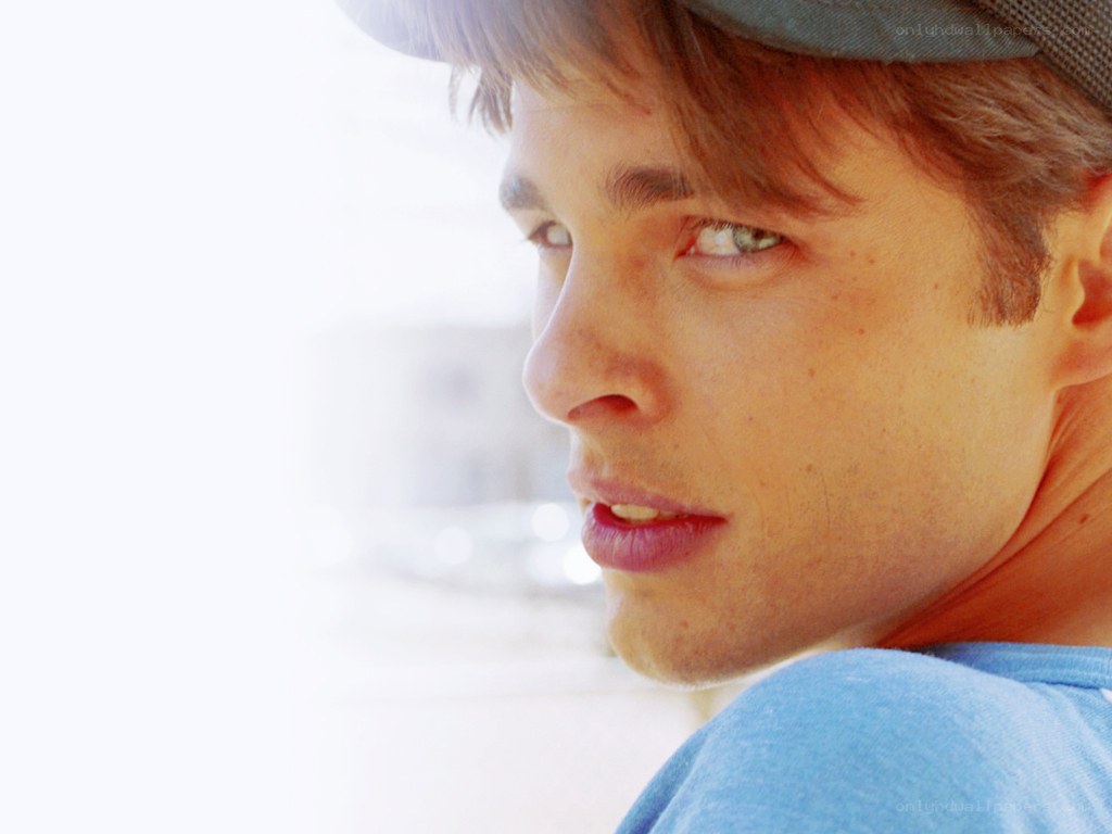 man in cap looking over shoulder