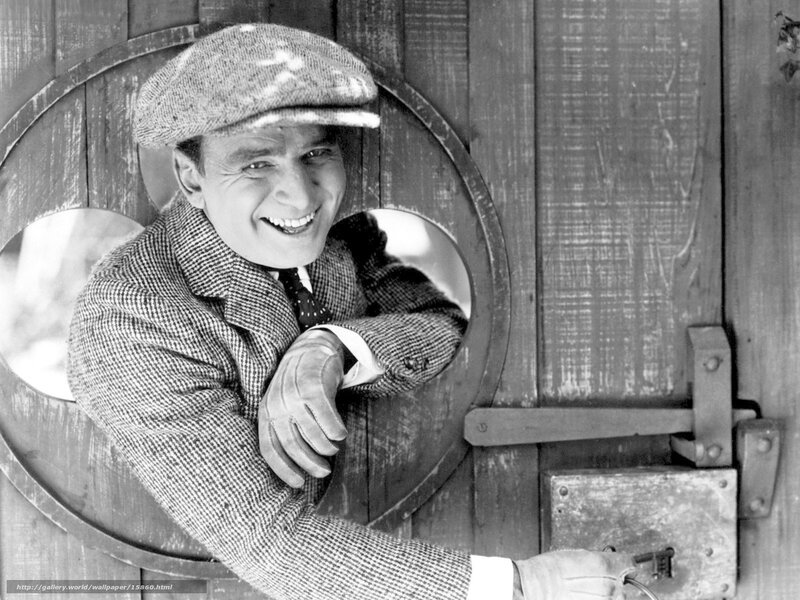 Man in cap smiling through door