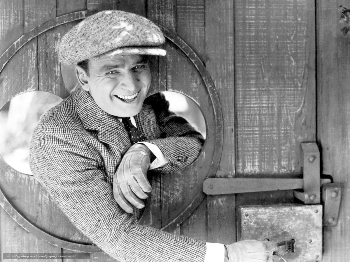 Man in cap smiling through door