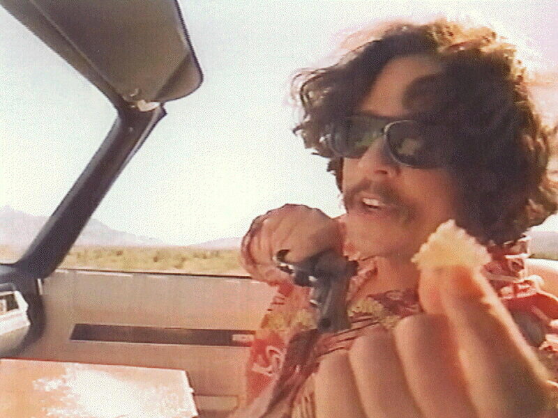 man in car eating snack