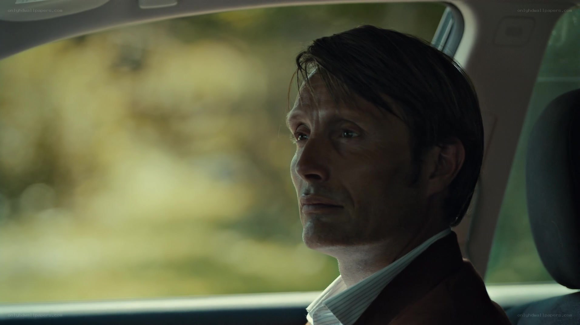 man in car looking out window