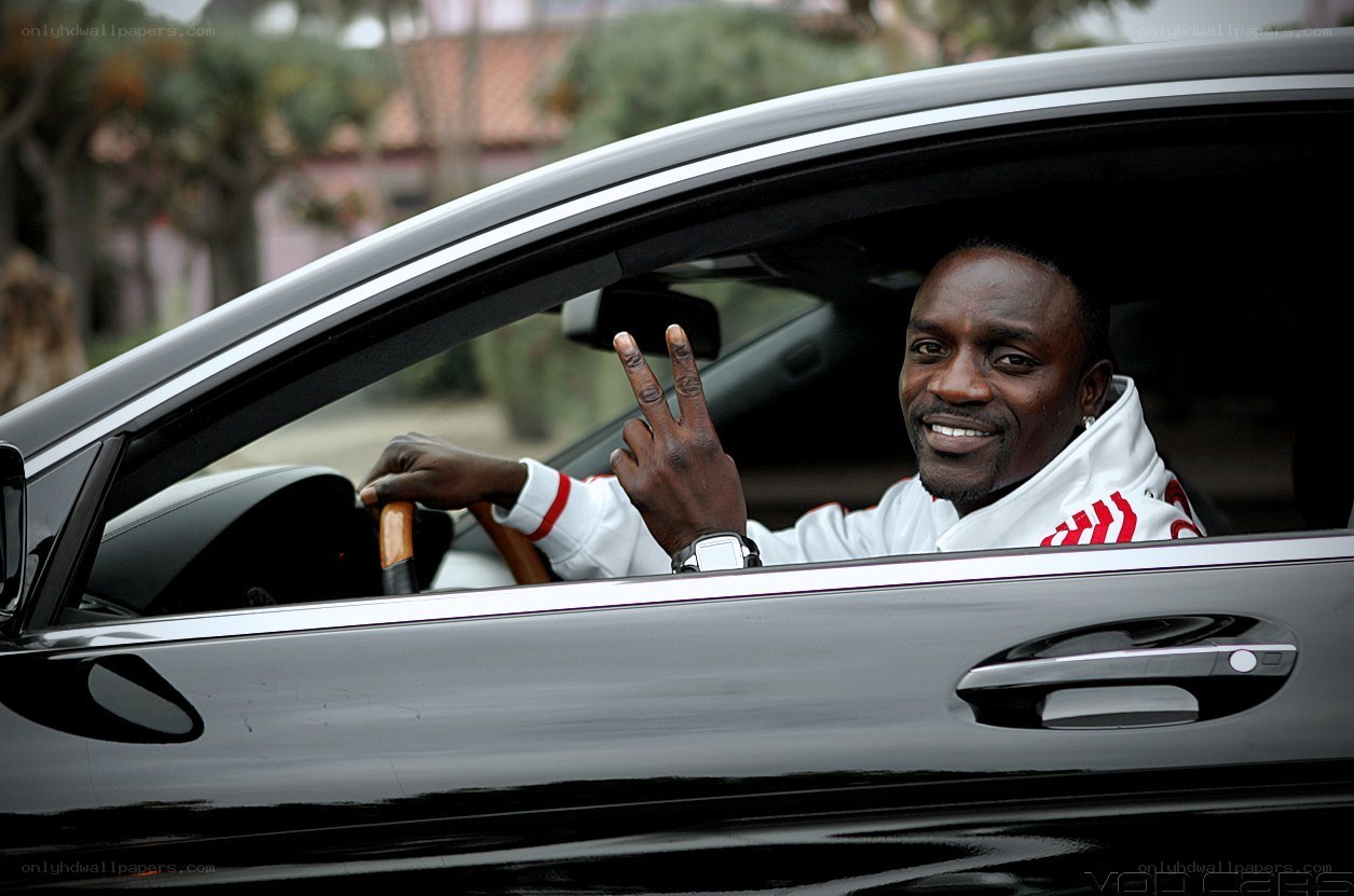 man in car making peace sign