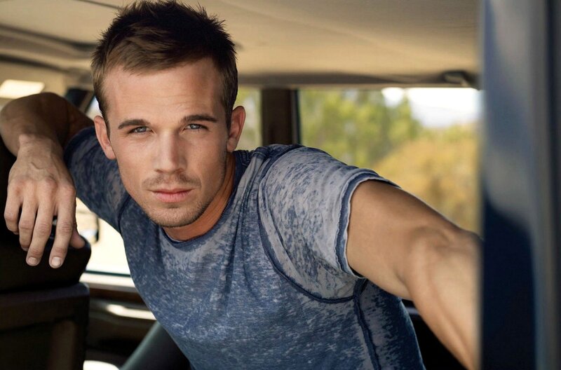 man in car wearing blue shirt