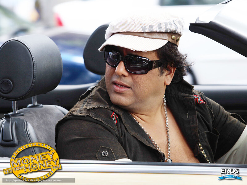 Man in car wearing cap and sunglasses