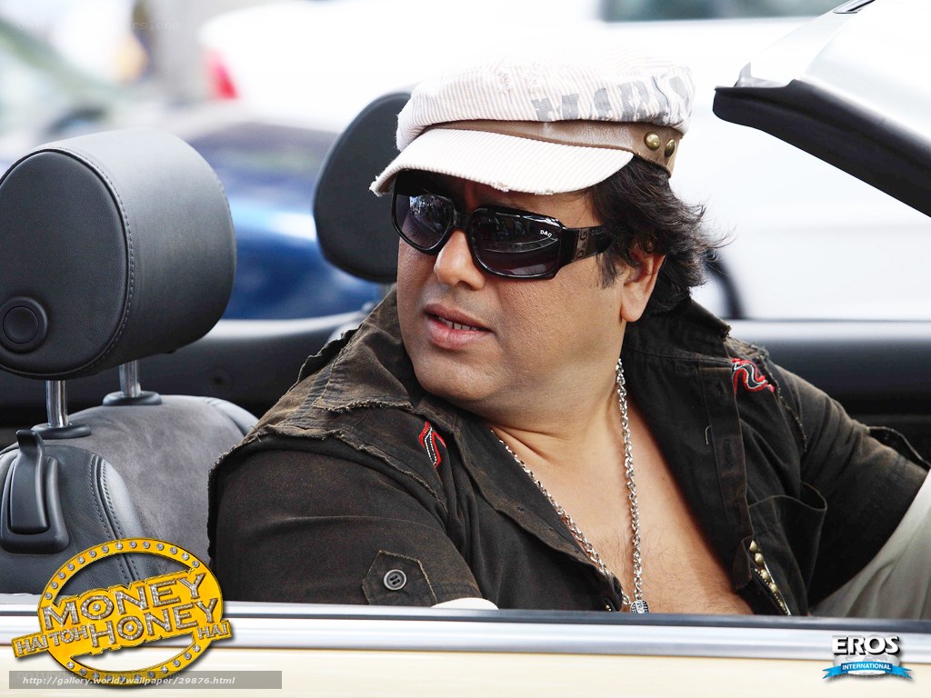 Man in car wearing cap and sunglasses