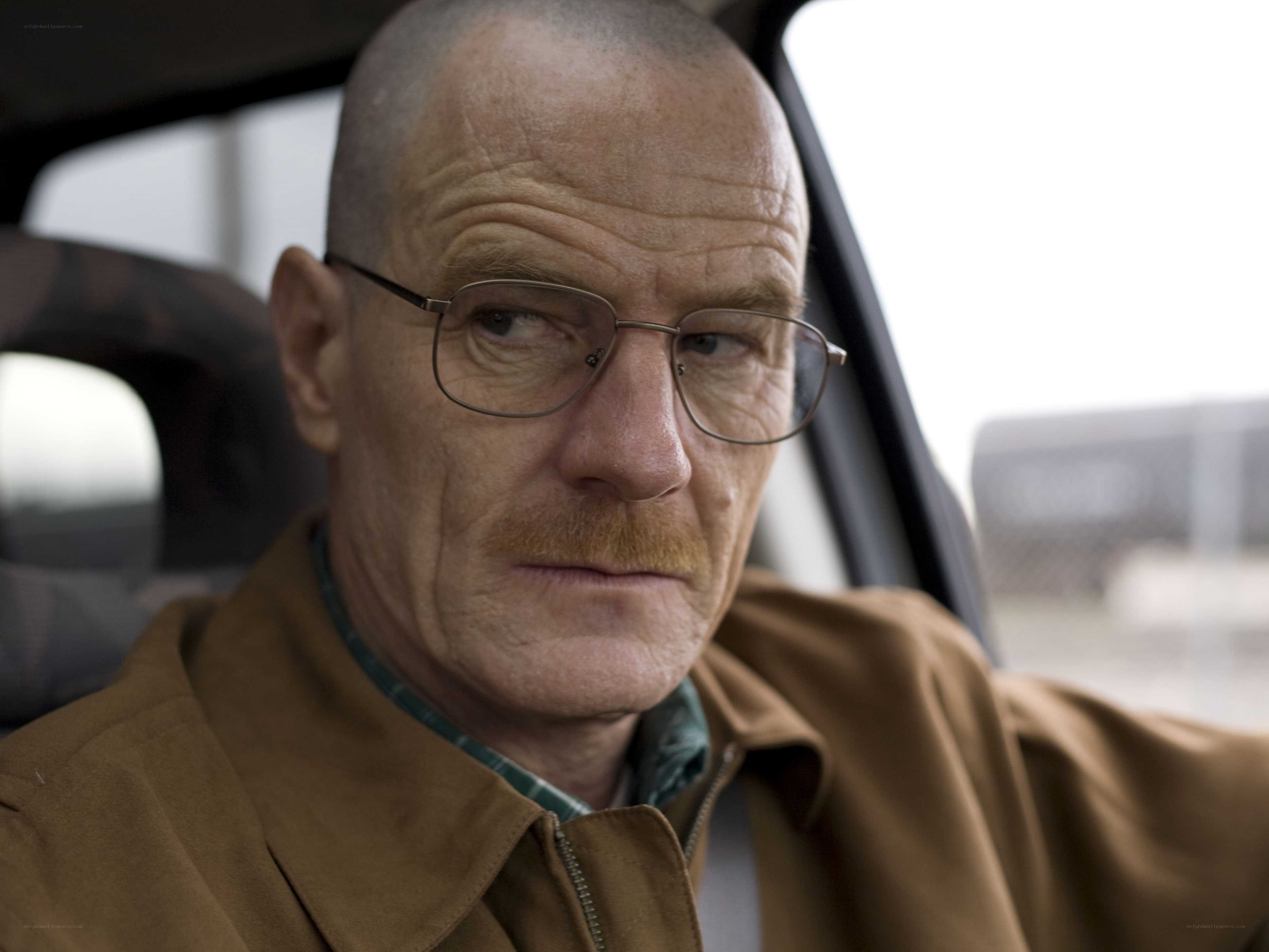 man in car wearing glasses