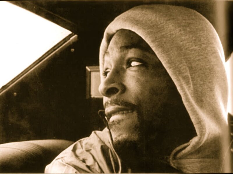 man in car wearing hoodie