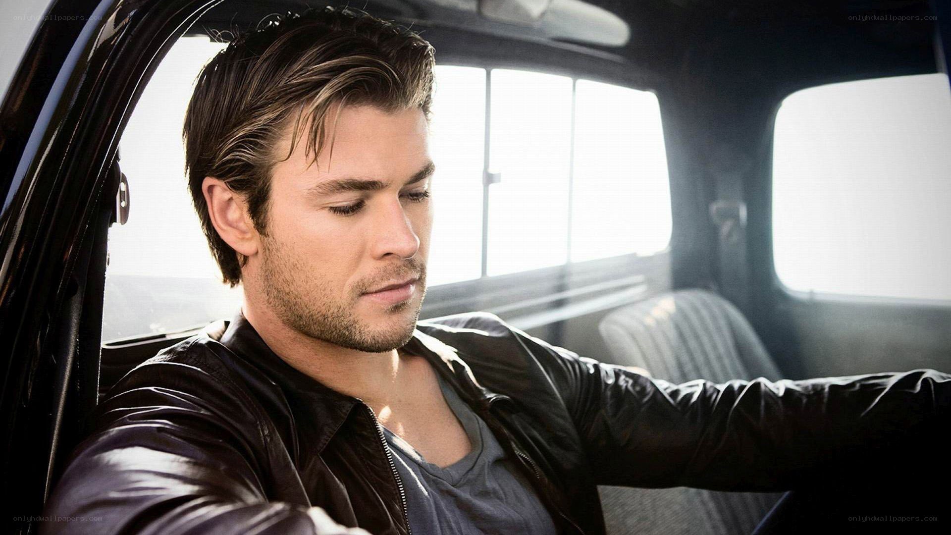 man in car wearing leather jacket