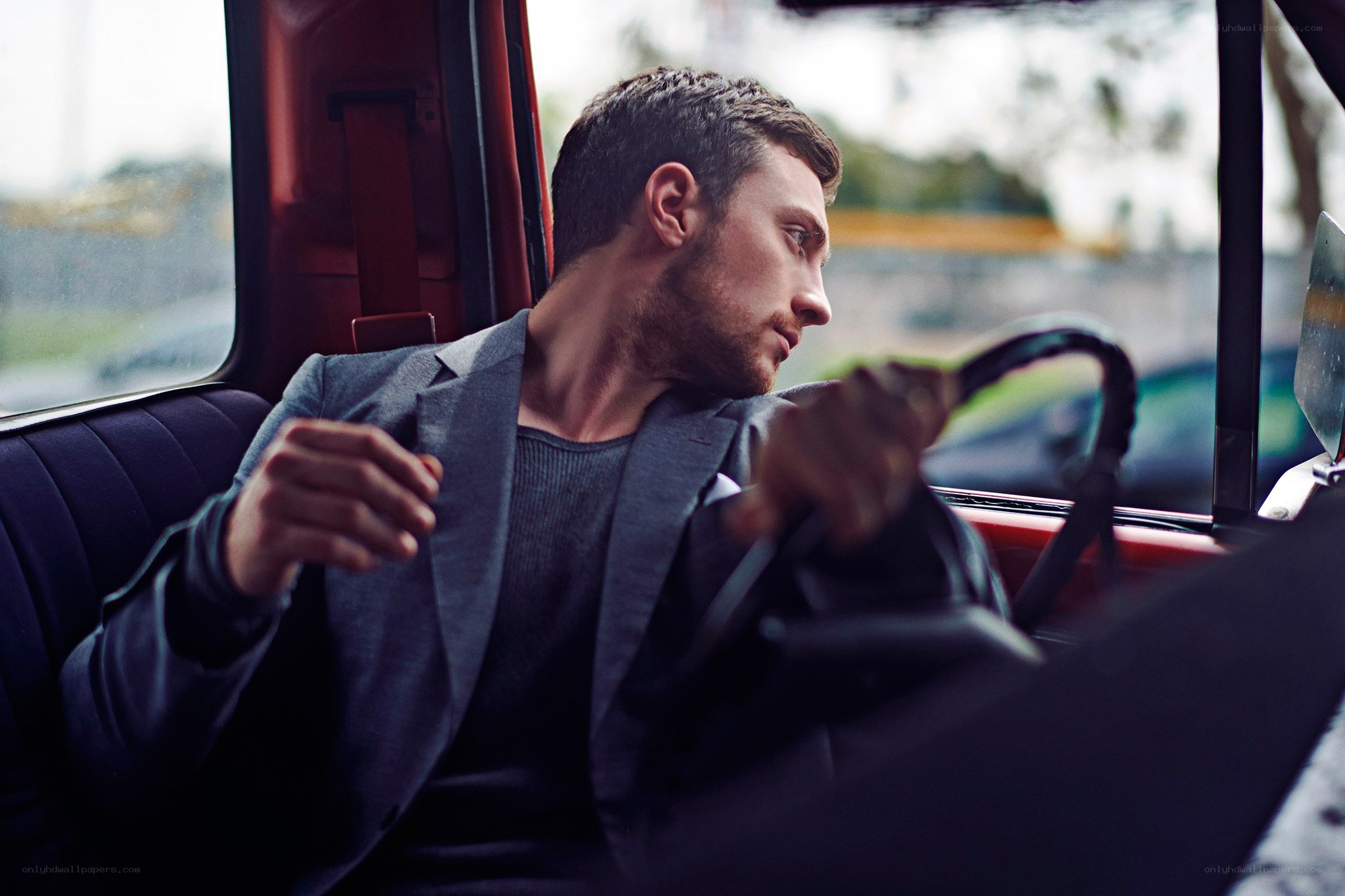 man in car wearing suit