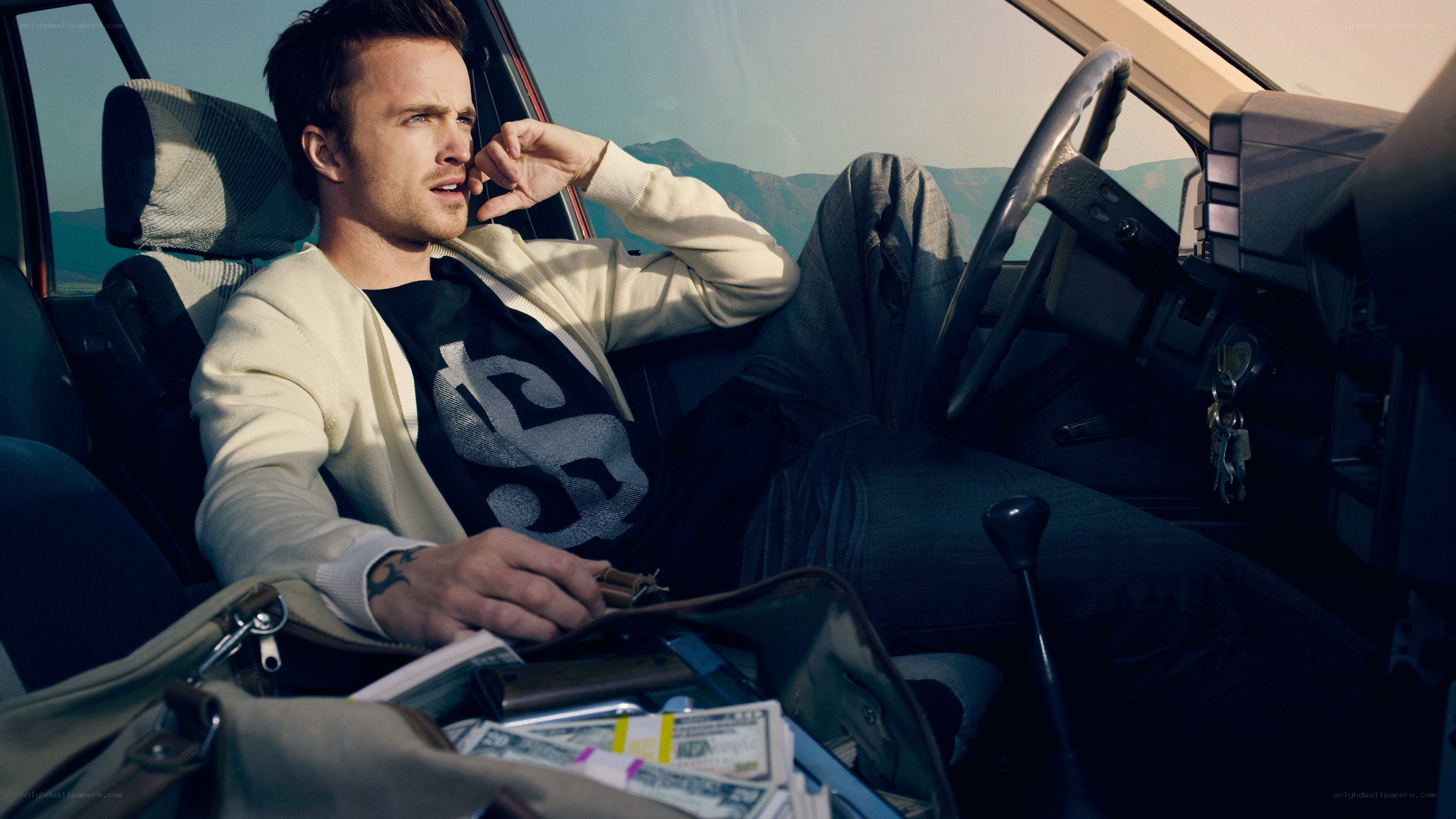 man in car with money
