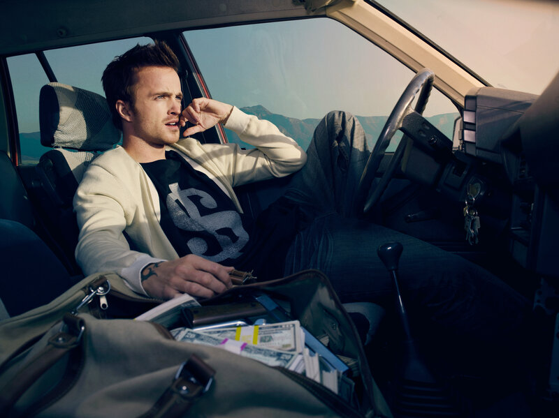 man in car with money bag