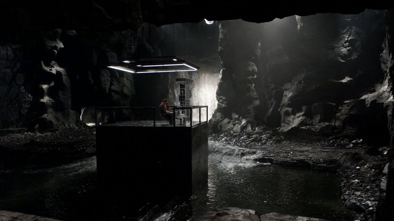 man in cave with platform