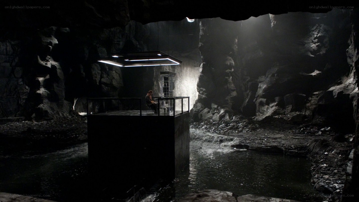 man in cave with platform