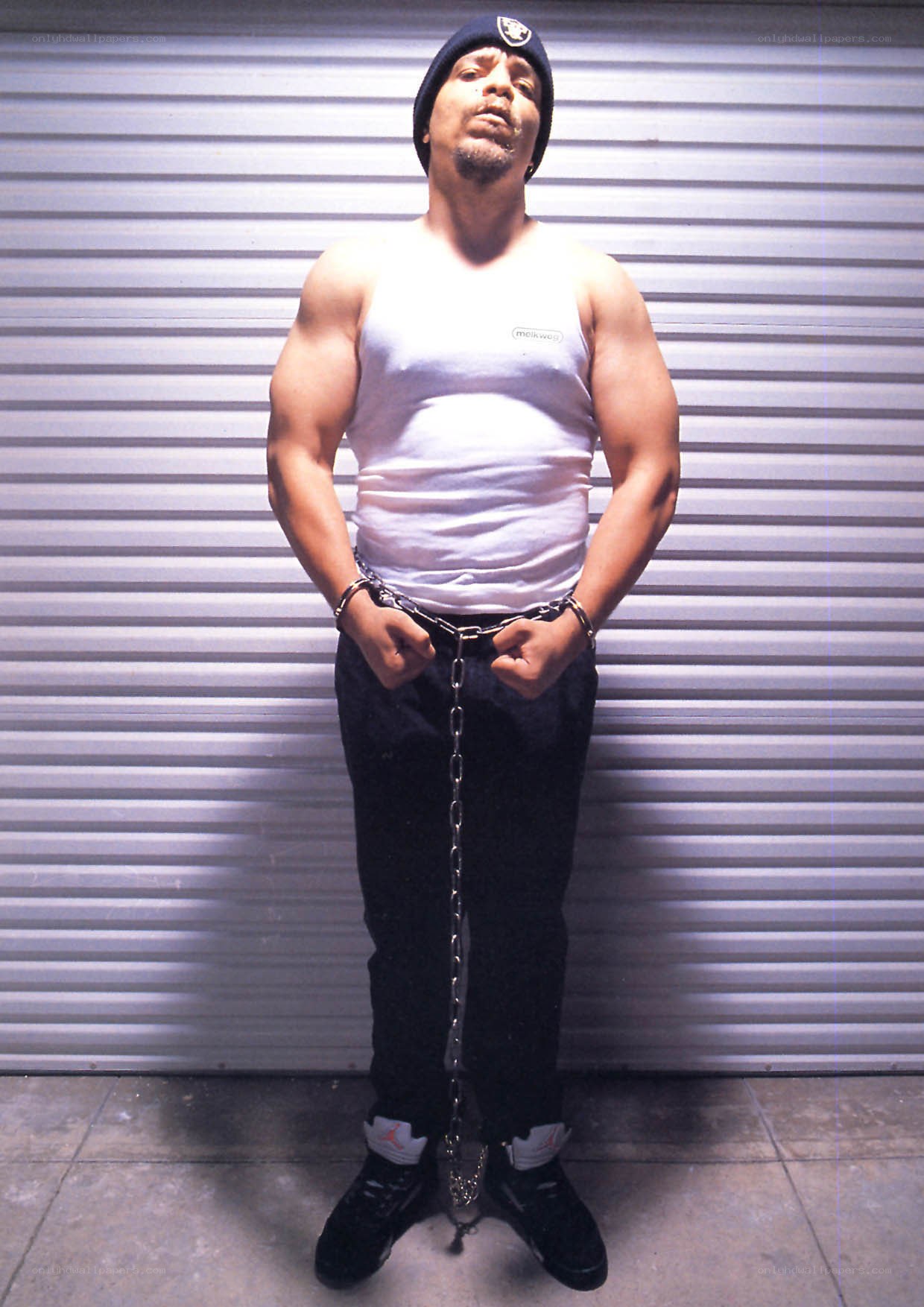 Man in chains against garage door