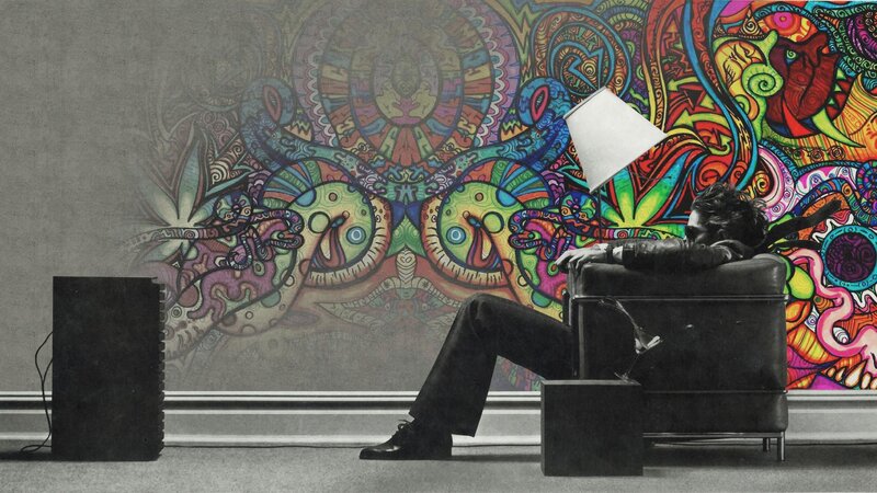 Man in chair with psychedelic mural