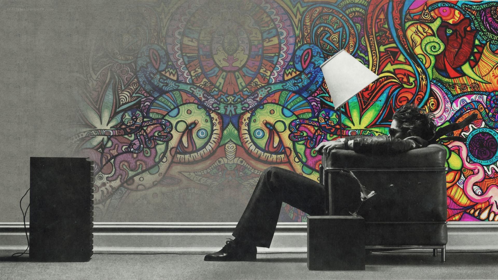Man in chair with psychedelic mural