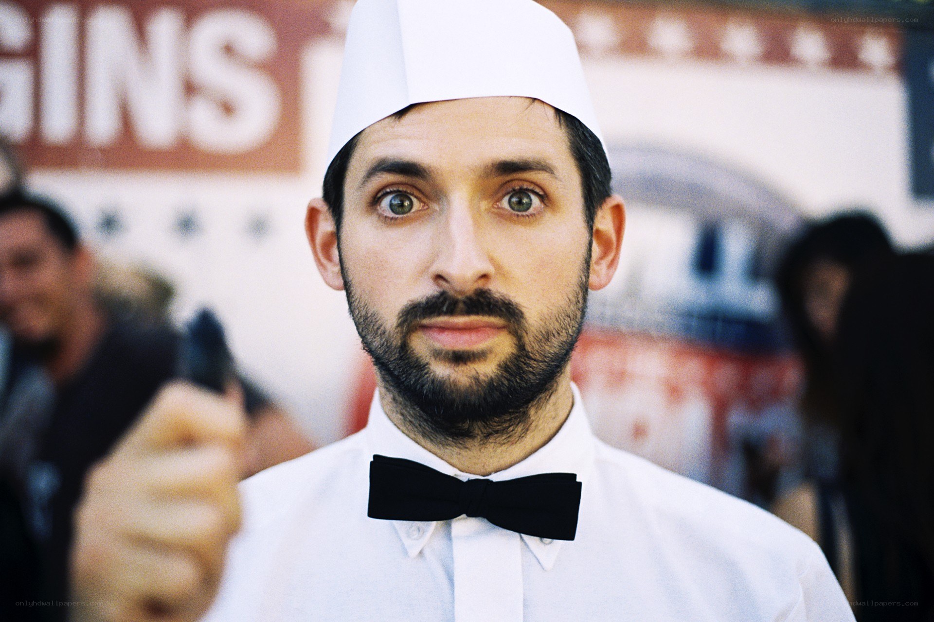 man in chef hat pointing gun
