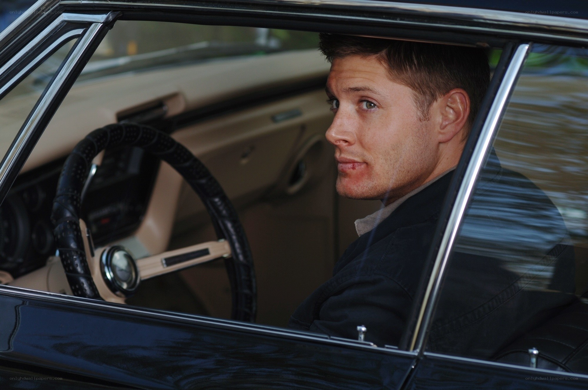 man in classic car interior