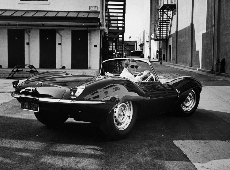 Man in classic car on street