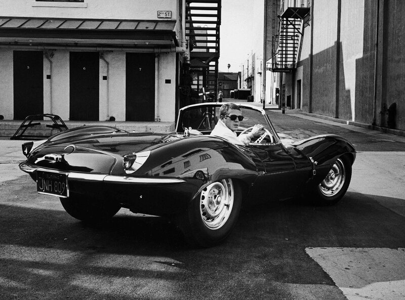 Man in classic car on street