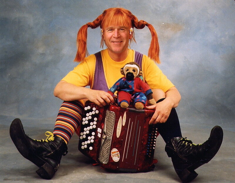 Man in clown costume with accordion