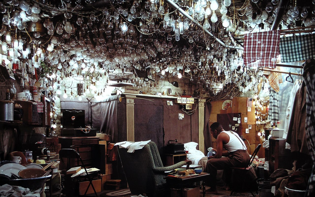 Man in cluttered room with light bulbs