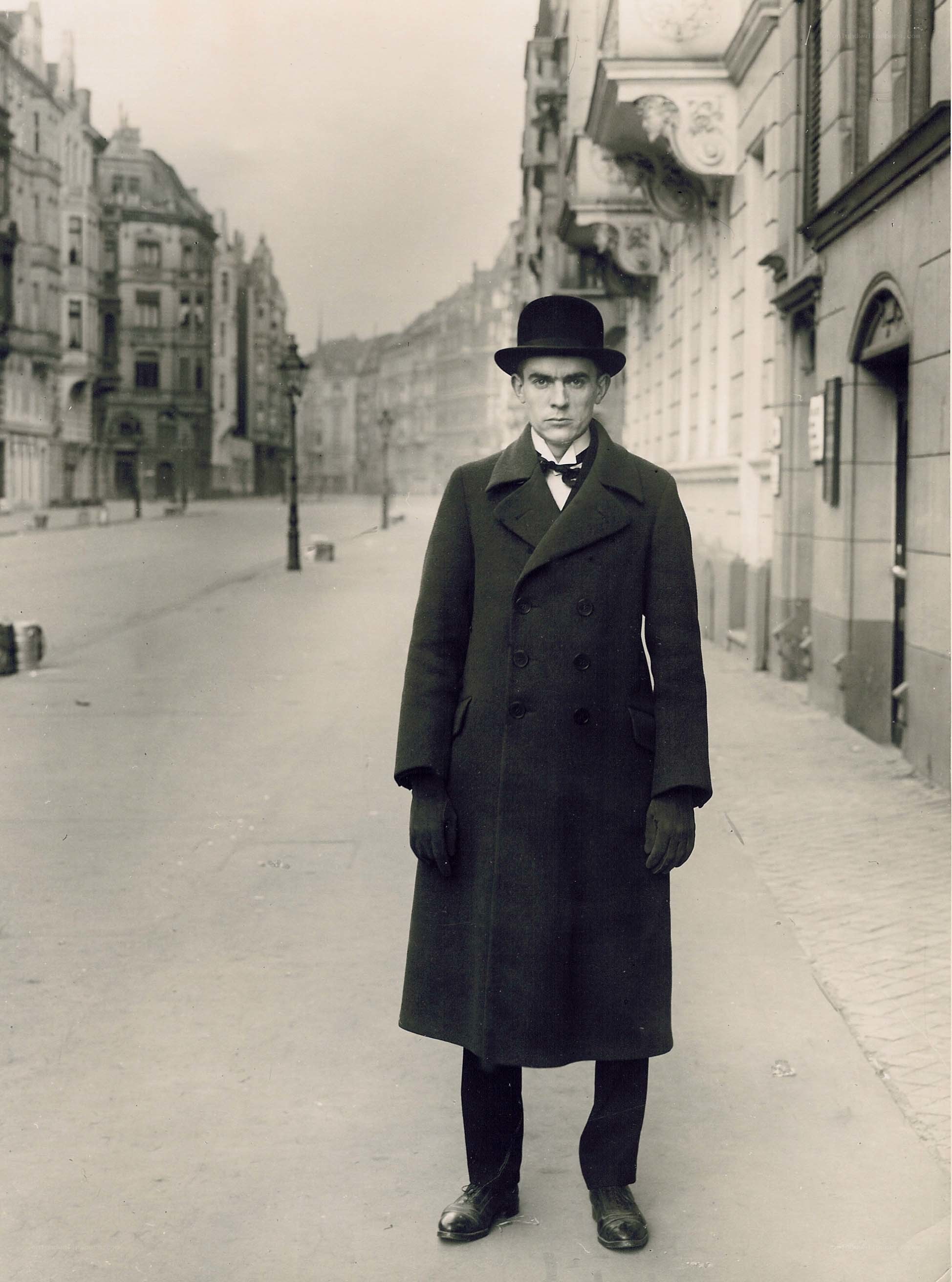 Man in coat and bowler hat