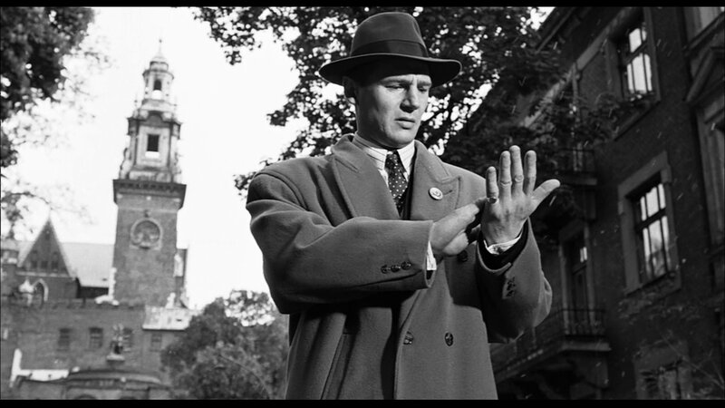 Man in coat and hat outdoors