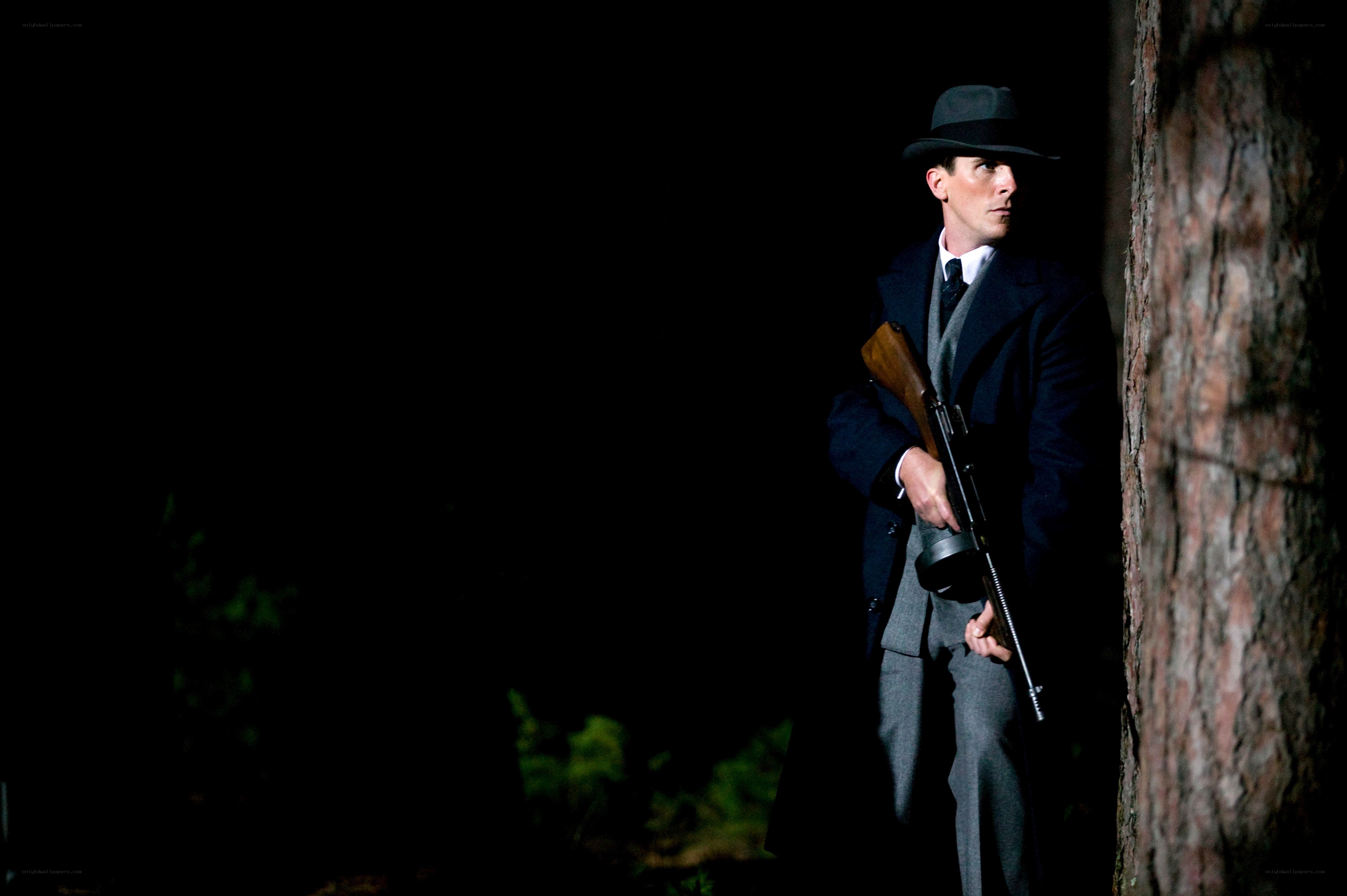 Man in coat holding rifle