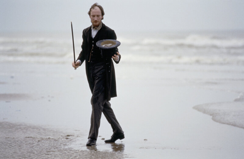 Man in coat on beach