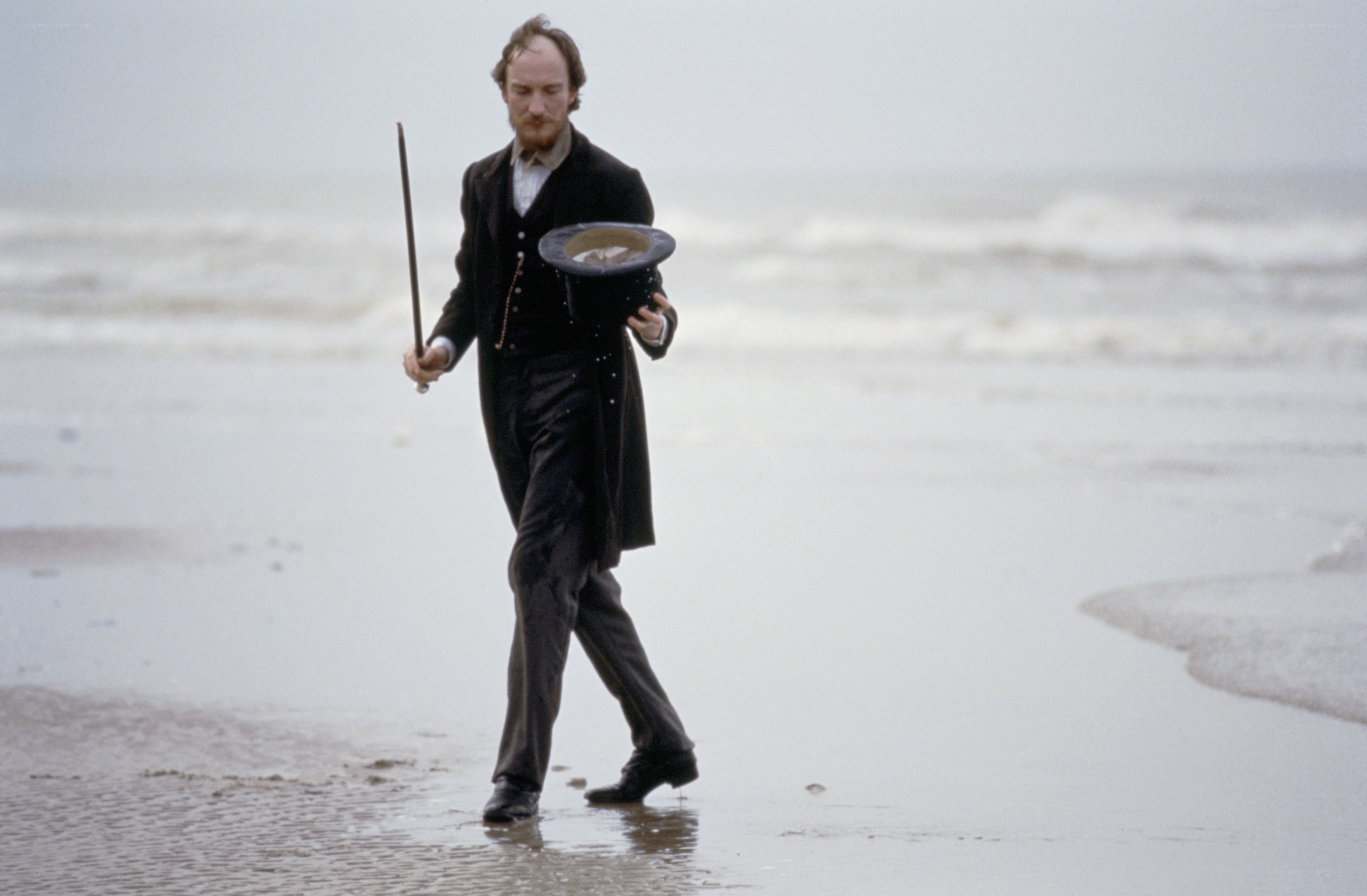 Man in coat on beach