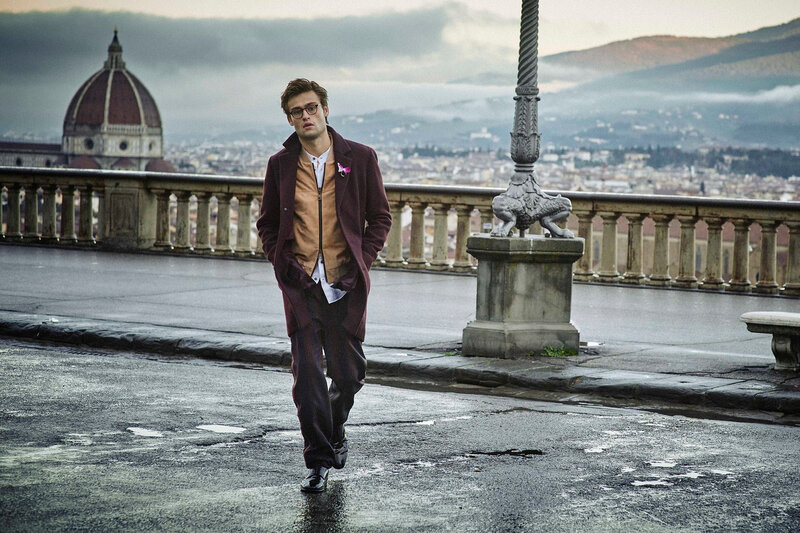 Man in coat on city overlook