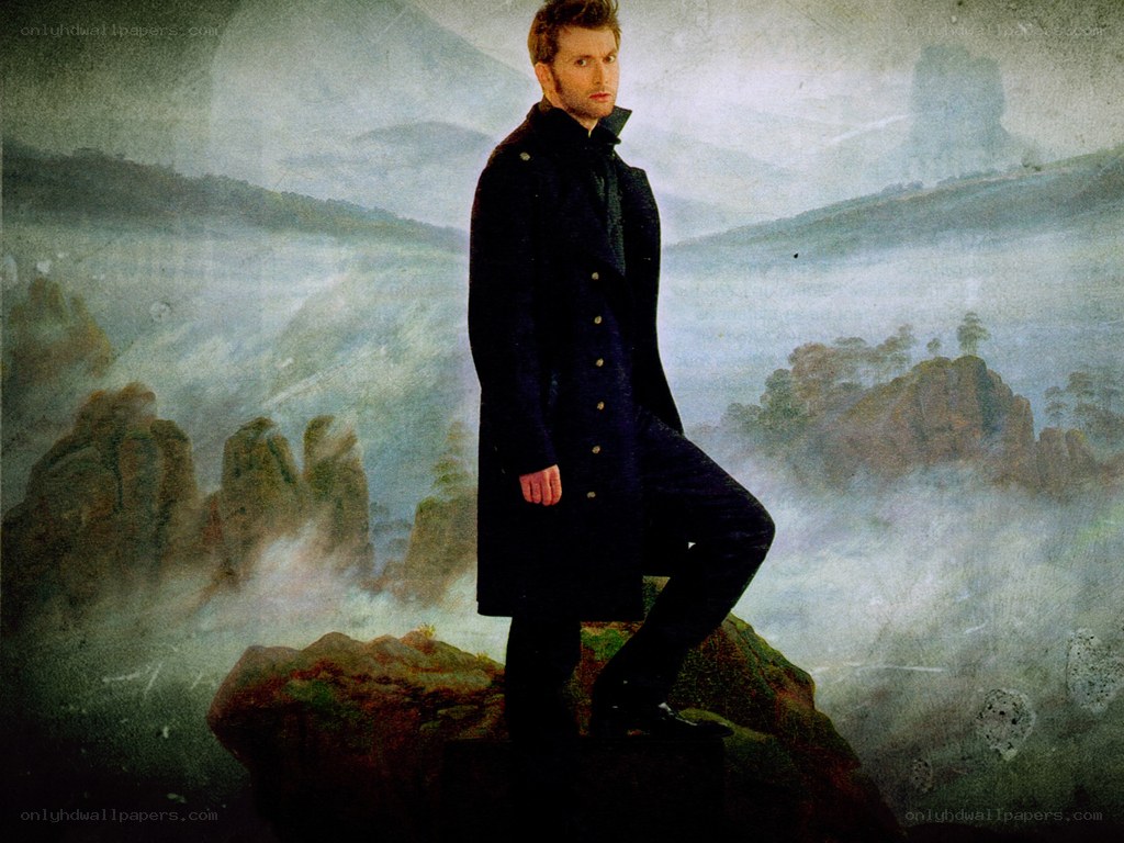 man in coat on rock