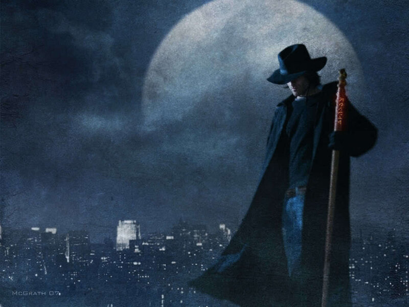 Man in coat with staff at night