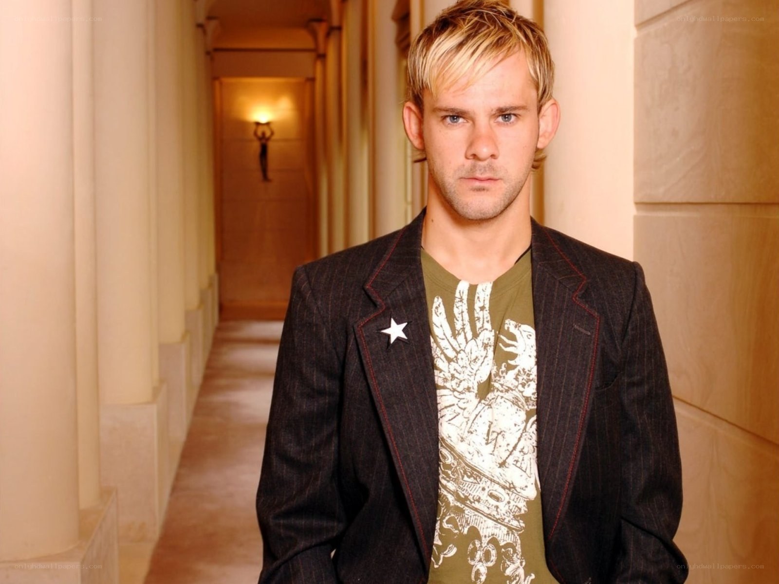 man in corridor wearing blazer