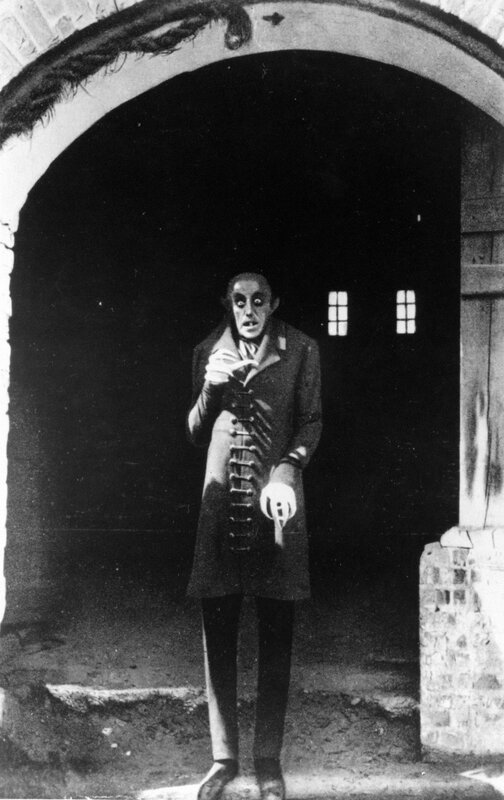 Man in costume at arched doorway