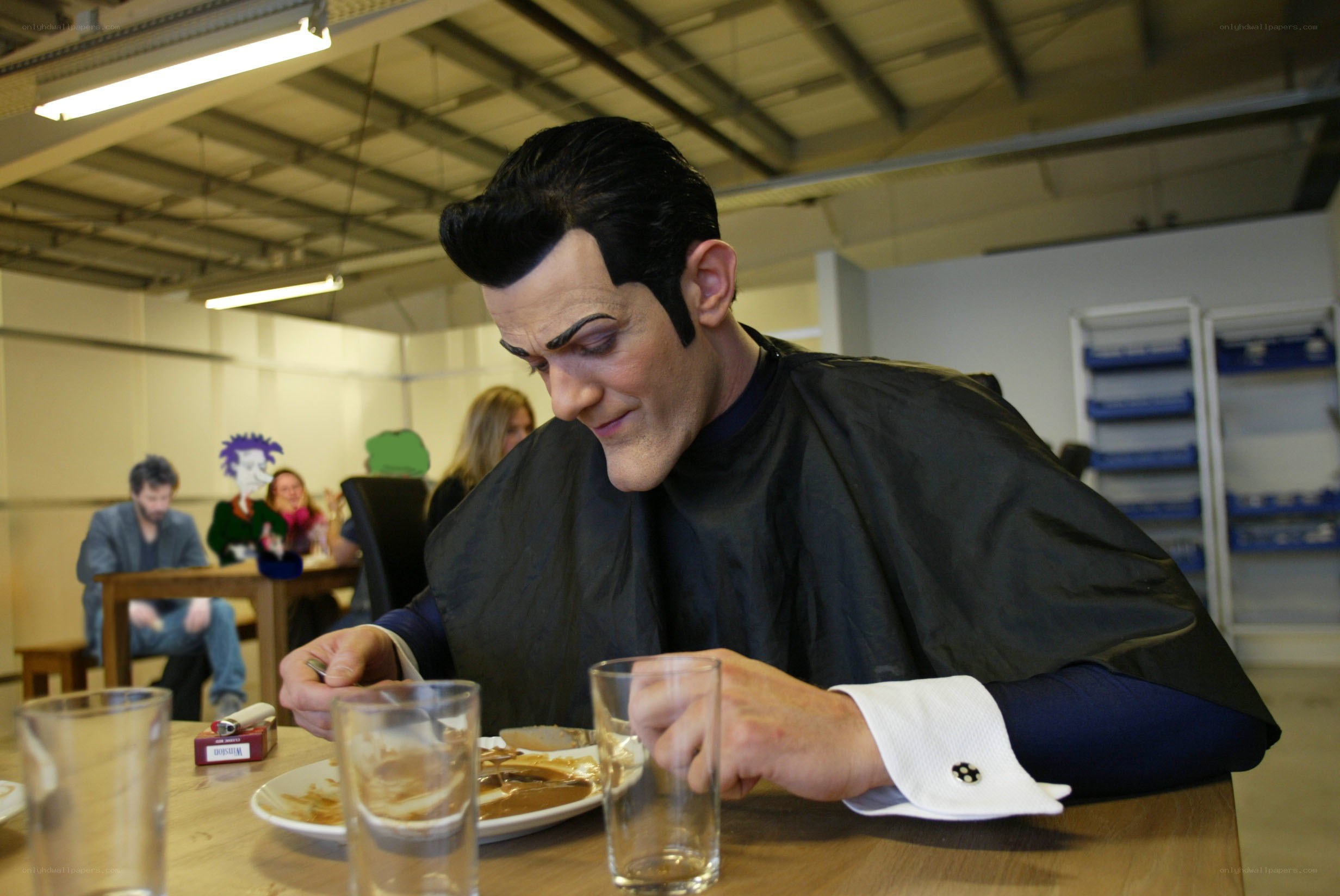 Man in costume eating at table