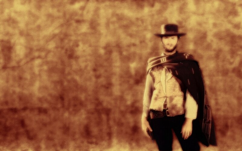 man in cowboy hat and poncho