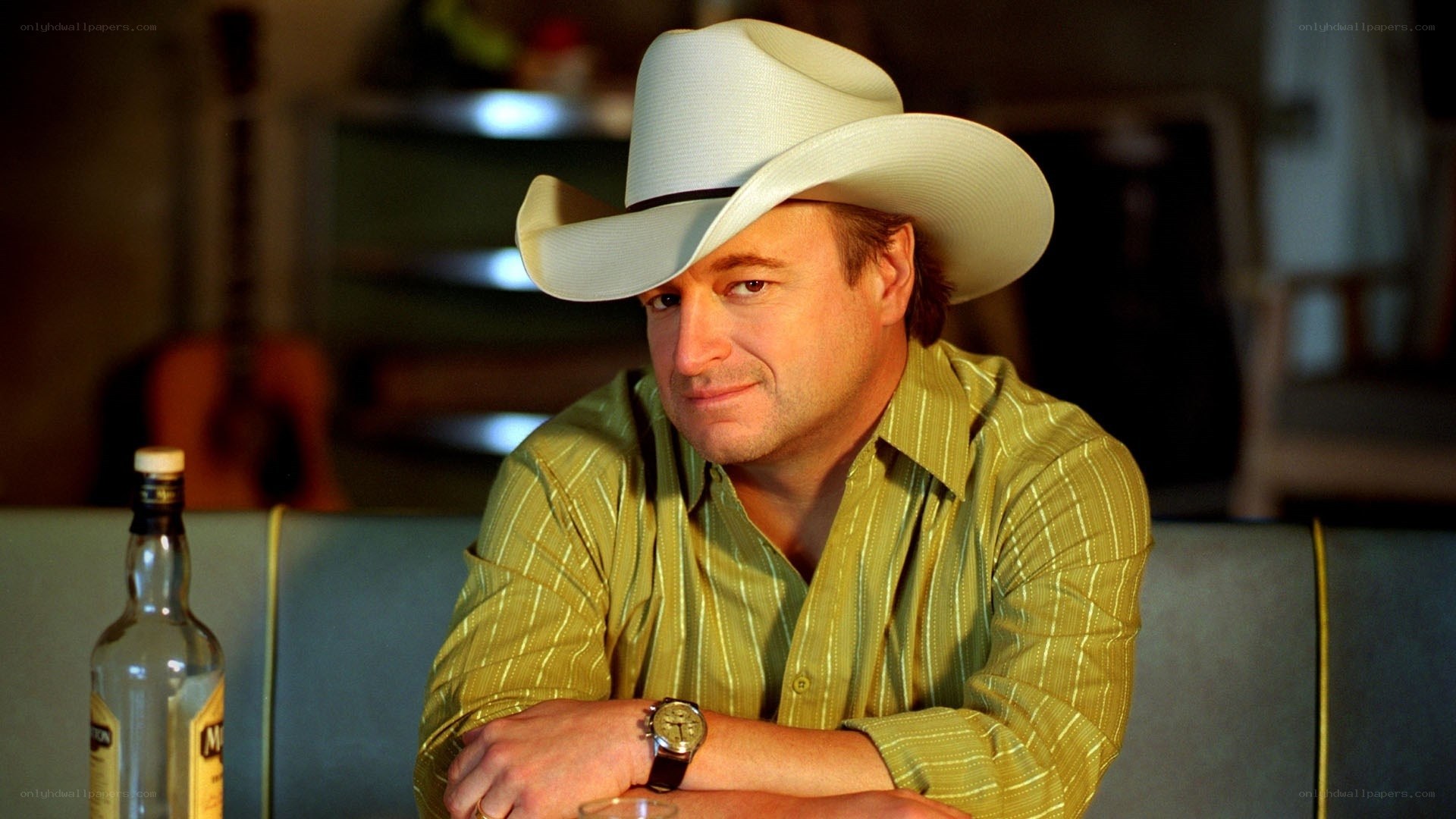 man in cowboy hat at bar