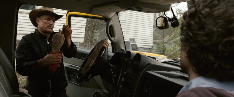 Man in cowboy hat by car
