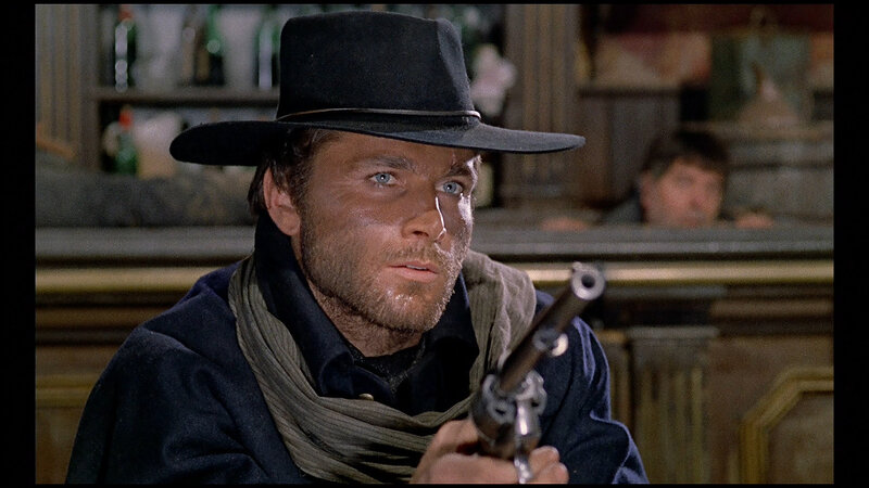 man in cowboy hat holding gun