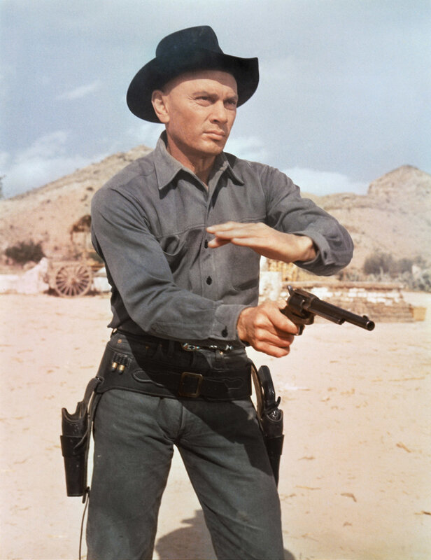 Man in cowboy hat holding gun